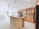 Kitchen with a breakfast bar, black appliances, and oak cabinets, offering a cozy and functional cooking space at 3105 S Canal Dr, Palm Harbor, FL 34684