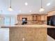 Kitchen featuring black appliances, tiled backsplash, and a breakfast bar, complemented by recessed lighting at 3105 S Canal Dr, Palm Harbor, FL 34684