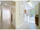 Hallway view to Laundry Room with washer, dryer and cabinets at 3105 S Canal Dr, Palm Harbor, FL 34684