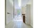 Bright laundry room with window, storage, and tile flooring at 3105 S Canal Dr, Palm Harbor, FL 34684