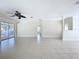 Spacious living room with tile floors, ceiling fan, and access to multiple rooms at 3105 S Canal Dr, Palm Harbor, FL 34684
