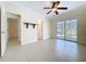 Living room showcasing an airy layout, tile flooring, and slider doors leading to the outdoor living area at 3105 S Canal Dr, Palm Harbor, FL 34684