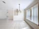 Bright open living area featuring a modern light fixture and tiled flooring at 3105 S Canal Dr, Palm Harbor, FL 34684