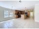 Bright open-concept with modern lighting, and a full kitchen along one wall at 3105 S Canal Dr, Palm Harbor, FL 34684