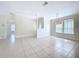 Open-concept living room featuring neutral colors and tiled floors at 3105 S Canal Dr, Palm Harbor, FL 34684