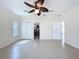 Bedroom featuring neutral walls, tile floors, ceiling fan, and ample closet space at 3105 S Canal Dr, Palm Harbor, FL 34684