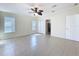 Bedroom featuring neutral walls, tile floors, ceiling fan, and ample closet space at 3105 S Canal Dr, Palm Harbor, FL 34684