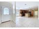 Open-concept kitchen with black appliances and a breakfast bar with seating, complemented by tile flooring at 3105 S Canal Dr, Palm Harbor, FL 34684