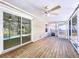 Inviting screened-in porch with ceiling fan and wood decking at 3105 S Canal Dr, Palm Harbor, FL 34684