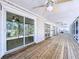Expansive screened-in porch with ceiling fans at 3105 S Canal Dr, Palm Harbor, FL 34684
