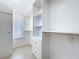 Spacious walk-in closet with custom shelving, drawers, and ample storage space with natural light from a window at 3105 S Canal Dr, Palm Harbor, FL 34684