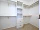 A practical walk-in closet offering custom shelving, drawers, and sufficient storage for efficient organization at 3105 S Canal Dr, Palm Harbor, FL 34684
