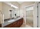 Well-lit bathroom featuring double sinks with granite countertops and access to the main bedroom at 3621 W Tacon St, Tampa, FL 33629