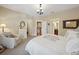 Spacious bedroom featuring soft carpet, classic chandelier, and doorways with views to other rooms at 3621 W Tacon St, Tampa, FL 33629