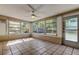 Relaxing sunroom with ceramic tile floor and many windows at 5002 54Th N Way, St Petersburg, FL 33709