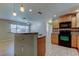 Open kitchen featuring a granite breakfast bar, wood-look tile floors, and black appliances at 5002 54Th N Way, St Petersburg, FL 33709