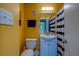 Bright bathroom featuring a single vanity, and vibrant yellow walls at 501 East Bay Dr # 601, Largo, FL 33770