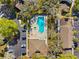 Aerial view of community pool featuring lounge chairs, parking, and landscaping at 5100 Burchette Rd # 3403, Tampa, FL 33647
