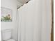Bathroom showcasing a white waffle shower curtain and quirky animal artwork at 5100 Burchette Rd # 3403, Tampa, FL 33647