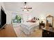Cozy bedroom with large window, ceiling fan, and neutral carpeting at 5100 Burchette Rd # 3403, Tampa, FL 33647