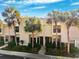 Well-maintained townhome exterior with vibrant palm trees and manicured landscaping at 5100 Burchette Rd # 3403, Tampa, FL 33647