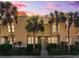 Inviting townhome exterior with palm trees and lush landscaping at sunset at 5100 Burchette Rd # 3403, Tampa, FL 33647