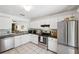 Well-lit kitchen with stainless steel appliances, white cabinets and black countertops at 5100 Burchette Rd # 3403, Tampa, FL 33647