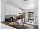 This open concept kitchen features stainless steel appliances and black countertops at 5100 Burchette Rd # 3403, Tampa, FL 33647