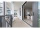 View of the balcony with iron railing and a peek into the living room through the sliding glass door at 5351 Bridge St # 99, Tampa, FL 33611