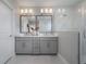 Well-lit bathroom featuring double vanity, modern fixtures, and a glass-enclosed shower at 5351 Bridge St # 99, Tampa, FL 33611