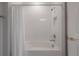 Bright bathroom featuring a shower-tub combo with white subway tile and modern fixtures at 5351 Bridge St # 99, Tampa, FL 33611