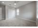 Neutral-toned bedroom featuring plush carpet, recessed lighting, and a window with white blinds at 5351 Bridge St # 99, Tampa, FL 33611