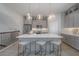 Open kitchen boasts a large island with seating, modern appliances, and stylish pendant lighting at 5351 Bridge St # 99, Tampa, FL 33611
