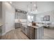 Elegant kitchen with island and farm sink, modern lighting, and an open layout to dining at 5351 Bridge St # 99, Tampa, FL 33611