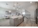 Spacious kitchen island with a farm sink, modern fixtures and open to the dining area at 5351 Bridge St # 99, Tampa, FL 33611