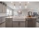 Modern kitchen with a large island, stainless steel appliances, and elegant lighting fixtures at 5351 Bridge St # 99, Tampa, FL 33611