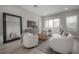 Bright living room with modern furniture, a large mirror, and sliding glass doors to a balcony at 5351 Bridge St # 99, Tampa, FL 33611