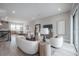 Spacious living room with modern decor, white sofas, and an open floor plan to the dining area at 5351 Bridge St # 99, Tampa, FL 33611