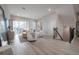 Bright living room featuring a sliding glass door to a balcony, comfortable seating, and modern decor at 5351 Bridge St # 99, Tampa, FL 33611