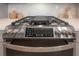 Close-up of stainless steel stove with digital controls and cooktop griddle against a herringbone tile backsplash at 5351 Bridge St # 99, Tampa, FL 33611