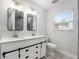 Bright bathroom with a double vanity, modern mirrors, and drawers, as well as a tiled walk-in shower at 5560 Frances Ave, New Port Richey, FL 34653