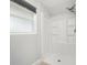 Bright bathroom with a stand-up shower and a large window at 5560 Frances Ave, New Port Richey, FL 34653