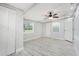 Bedroom featuring wood-look floors, natural light, and a ceiling fan at 5560 Frances Ave, New Port Richey, FL 34653