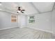 Bedroom featuring wood-look floors, natural light, and a ceiling fan at 5560 Frances Ave, New Port Richey, FL 34653