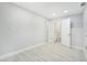 Spacious bedroom featuring neutral paint, wood-look flooring, and ensuite bathroom at 5560 Frances Ave, New Port Richey, FL 34653