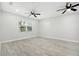 Bright bedroom features two ceiling fans and wood-look floors throughout at 5560 Frances Ave, New Port Richey, FL 34653