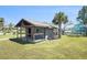 Charming property with a quaint, covered porch surrounded by a well-manicured lawn and mature landscaping at 5560 Frances Ave, New Port Richey, FL 34653