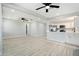 Bright, open-concept living space with wood-look flooring and modern kitchen at 5560 Frances Ave, New Port Richey, FL 34653
