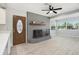 Bright living room featuring a decorative fireplace, wood-look floors, and a front door at 5560 Frances Ave, New Port Richey, FL 34653