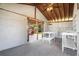 Enclosed outdoor area with a sink, preparation table, and an attached patio with outdoor seating at 5560 Frances Ave, New Port Richey, FL 34653